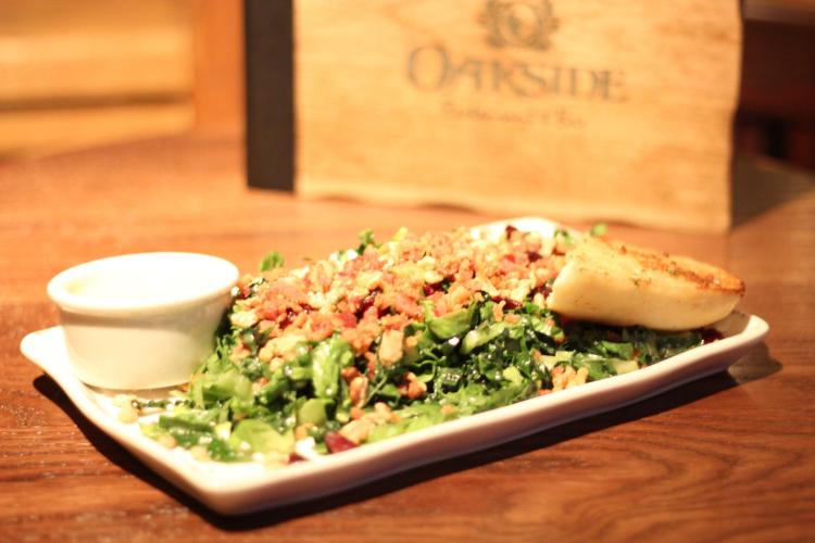 Ein Teller mit Salat, ein Stück Brot und ein Becher mit Dressing aus dem Oakside Restaurant in Big Bear Lake, CA.